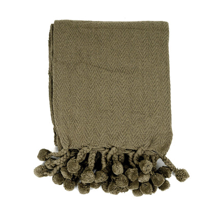 Coperta in cotone Vesla con nappe intrecciate a pompon in verde